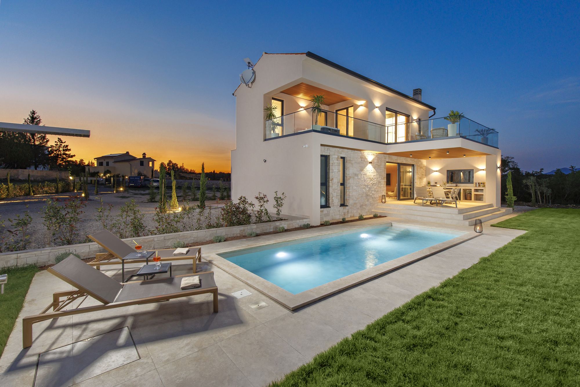 Lit private pool and Casa Mayren villa on a summer evening