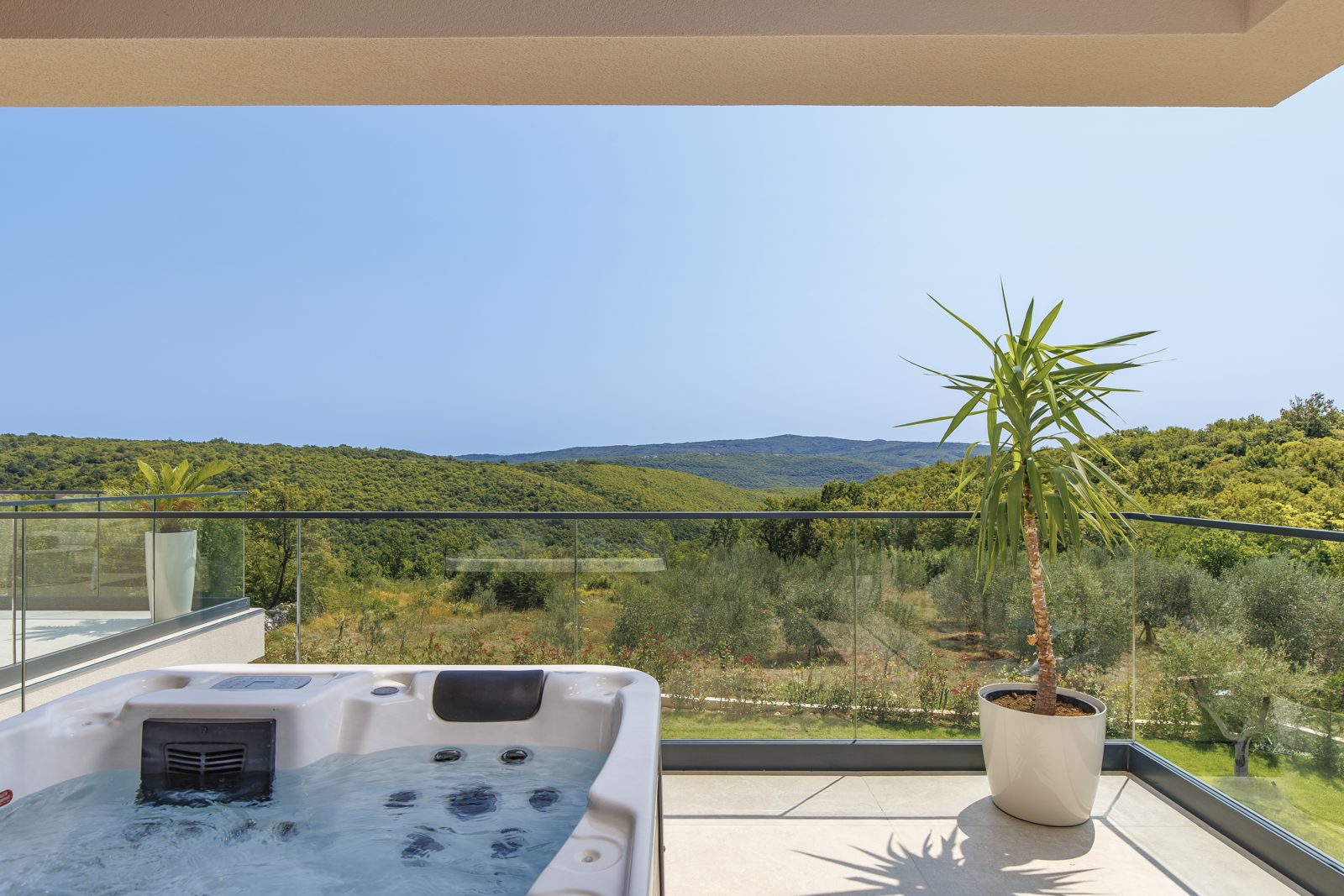 Private hot tub on the upper terrace overlooking hills and olive groves