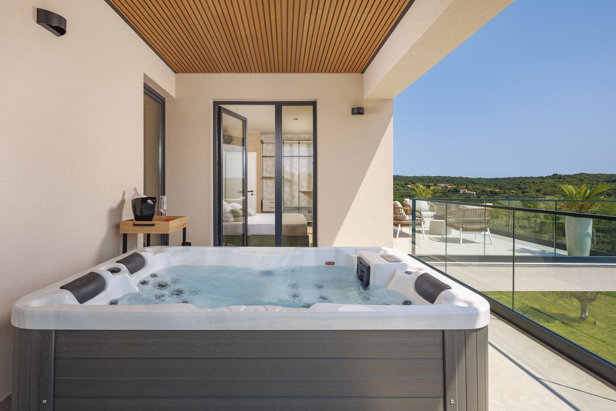 Private hot tub on the terrace overlooking green hills