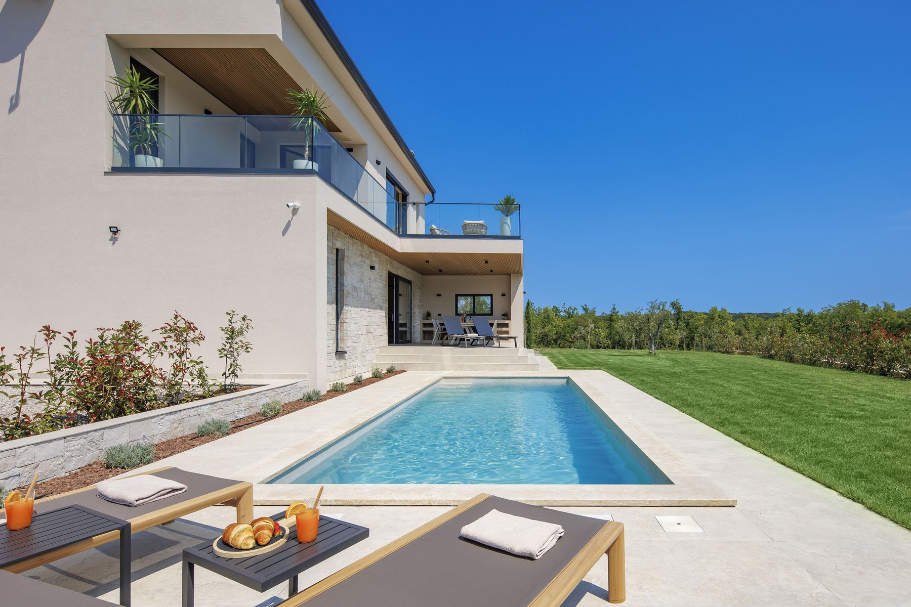 Loungers by the private pool on a summer afternoon